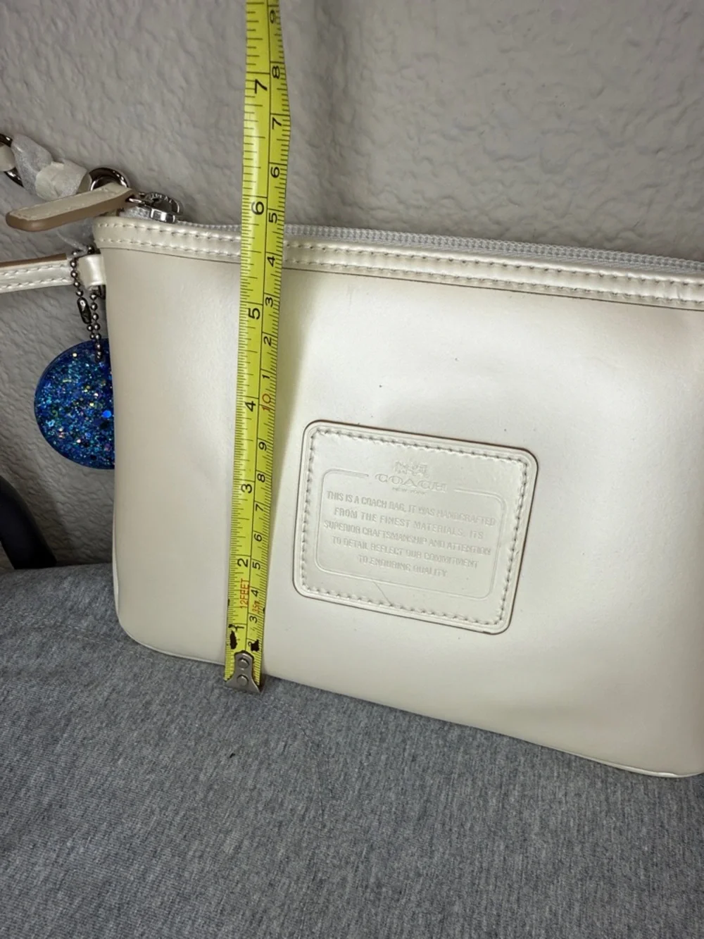 Coach Shimmering Ivory Leather Large Wristlet Clutch with Blue Glitter Charm